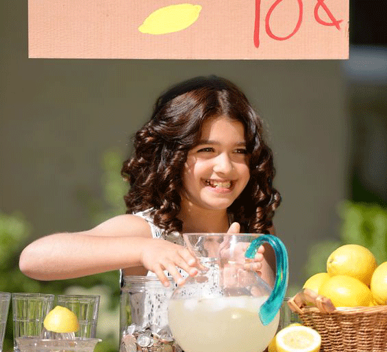 girl selling lemonade at stand